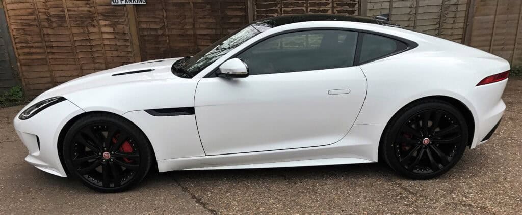 Car accident repair for sleek white sports car with damage. Expert collision repair and restoration.