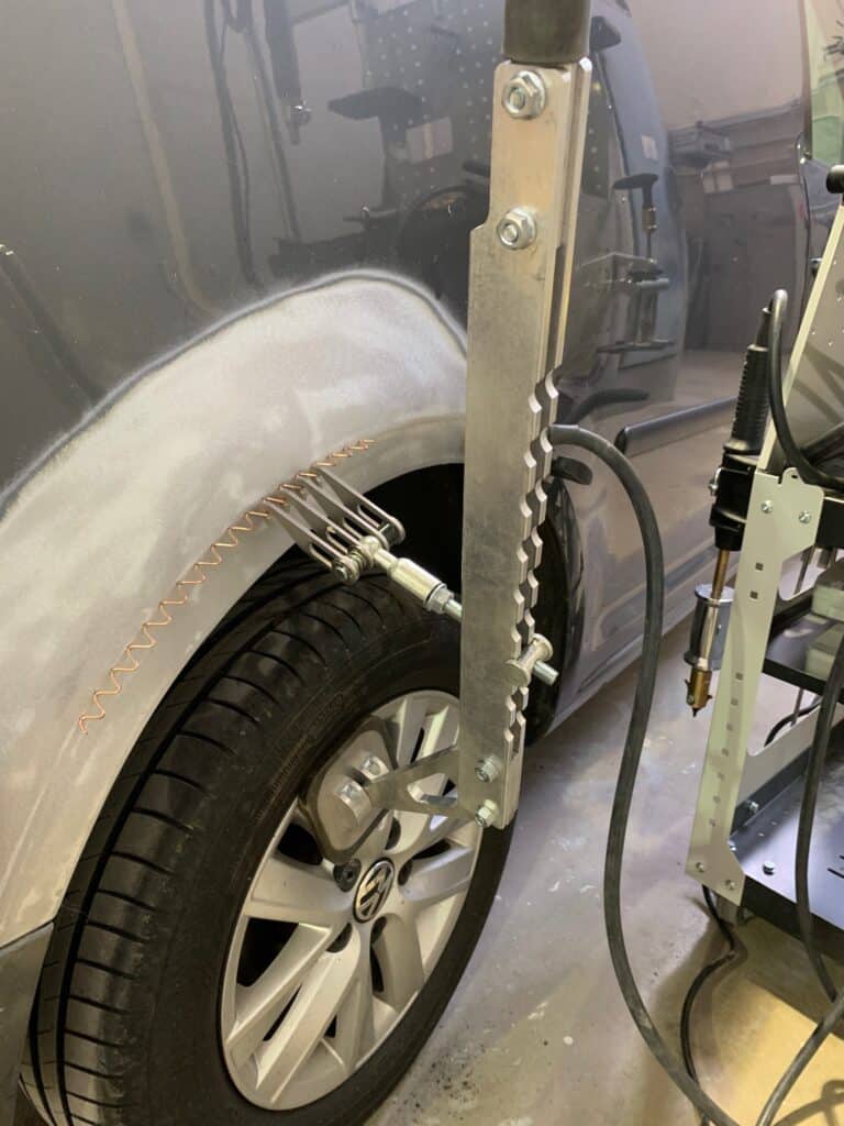 Vehicle undergoing frame straightening after a car accident for repair.