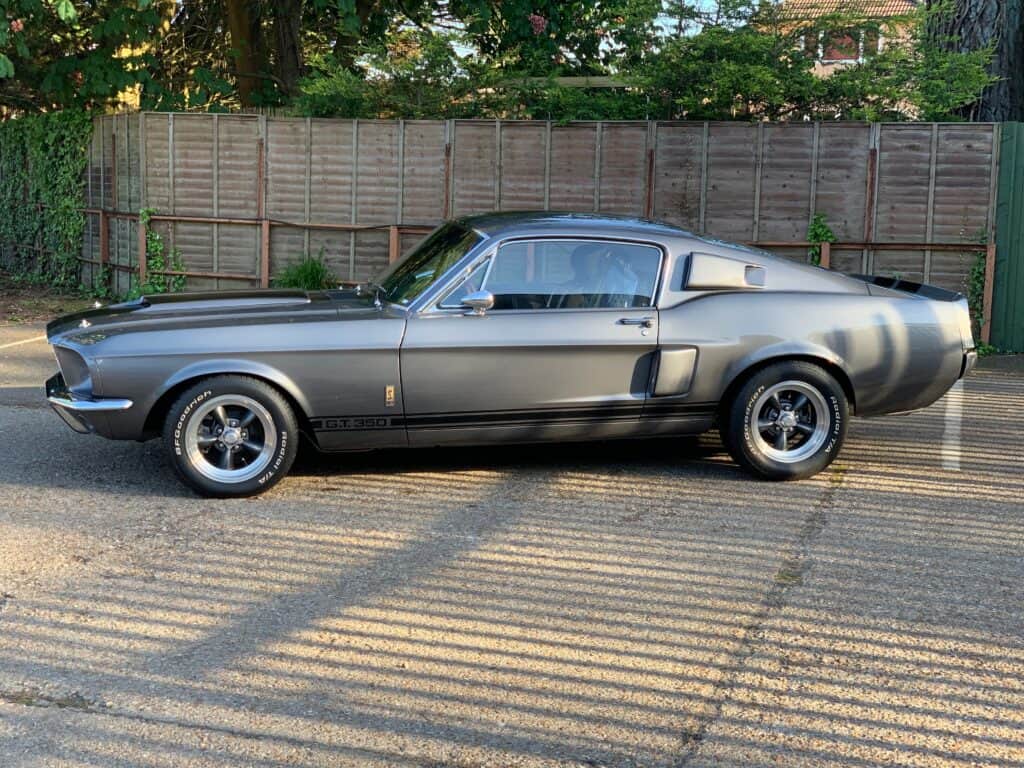 Classic Ford Mustang car in a repair yard, ready for collision repair services.