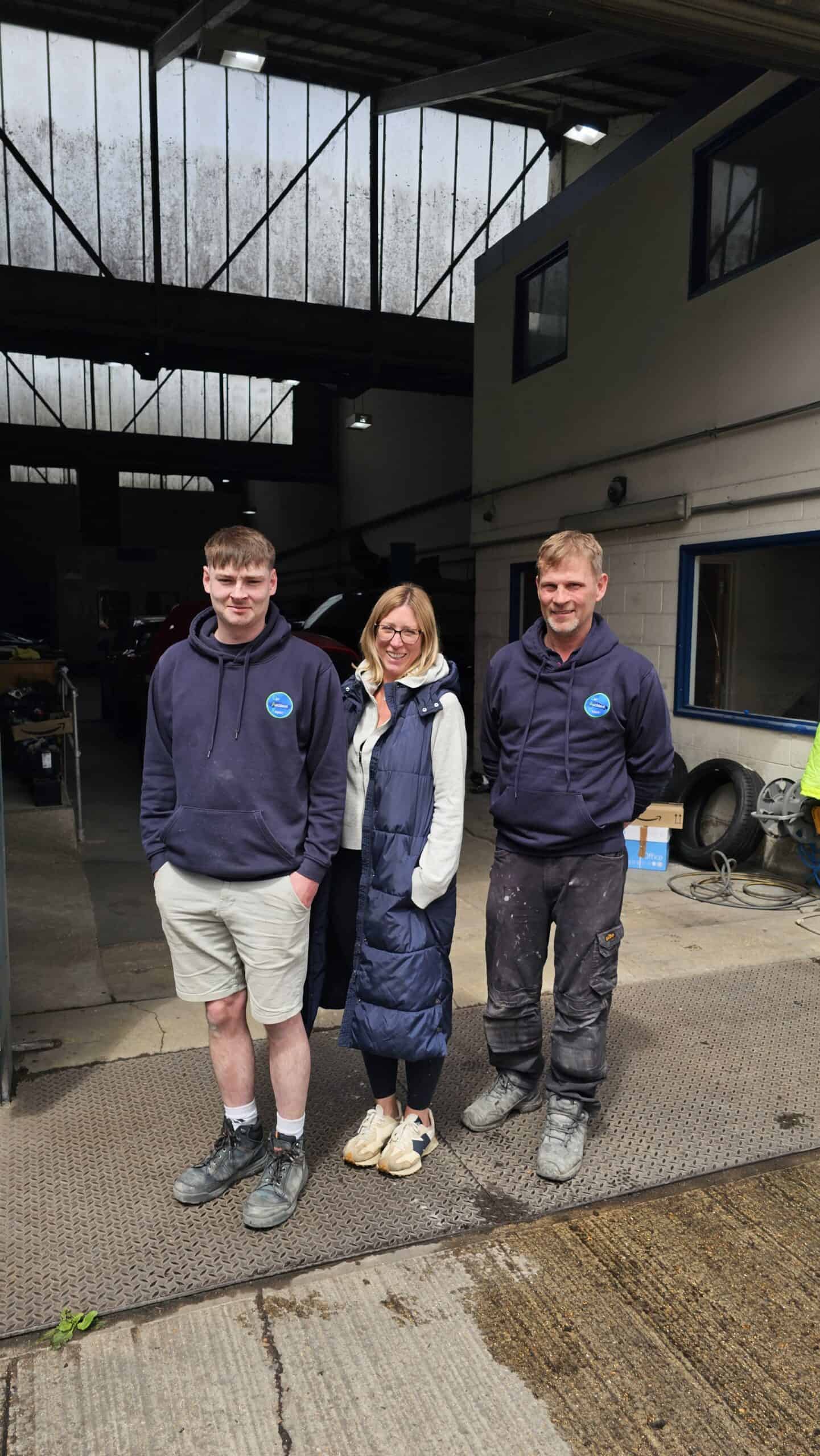 Skilled team at auto repair workshop ready for car accident repairs.