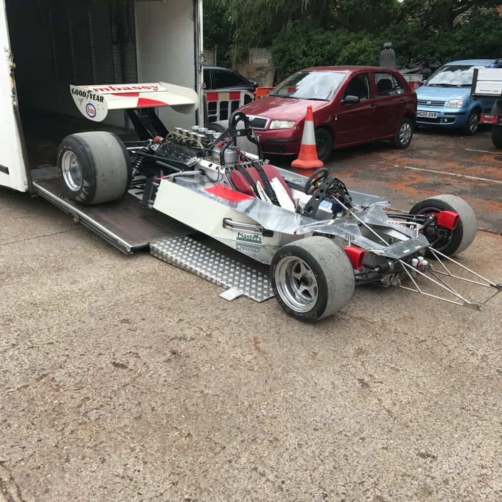 Damaged race car, ready for restore at auto body shop.